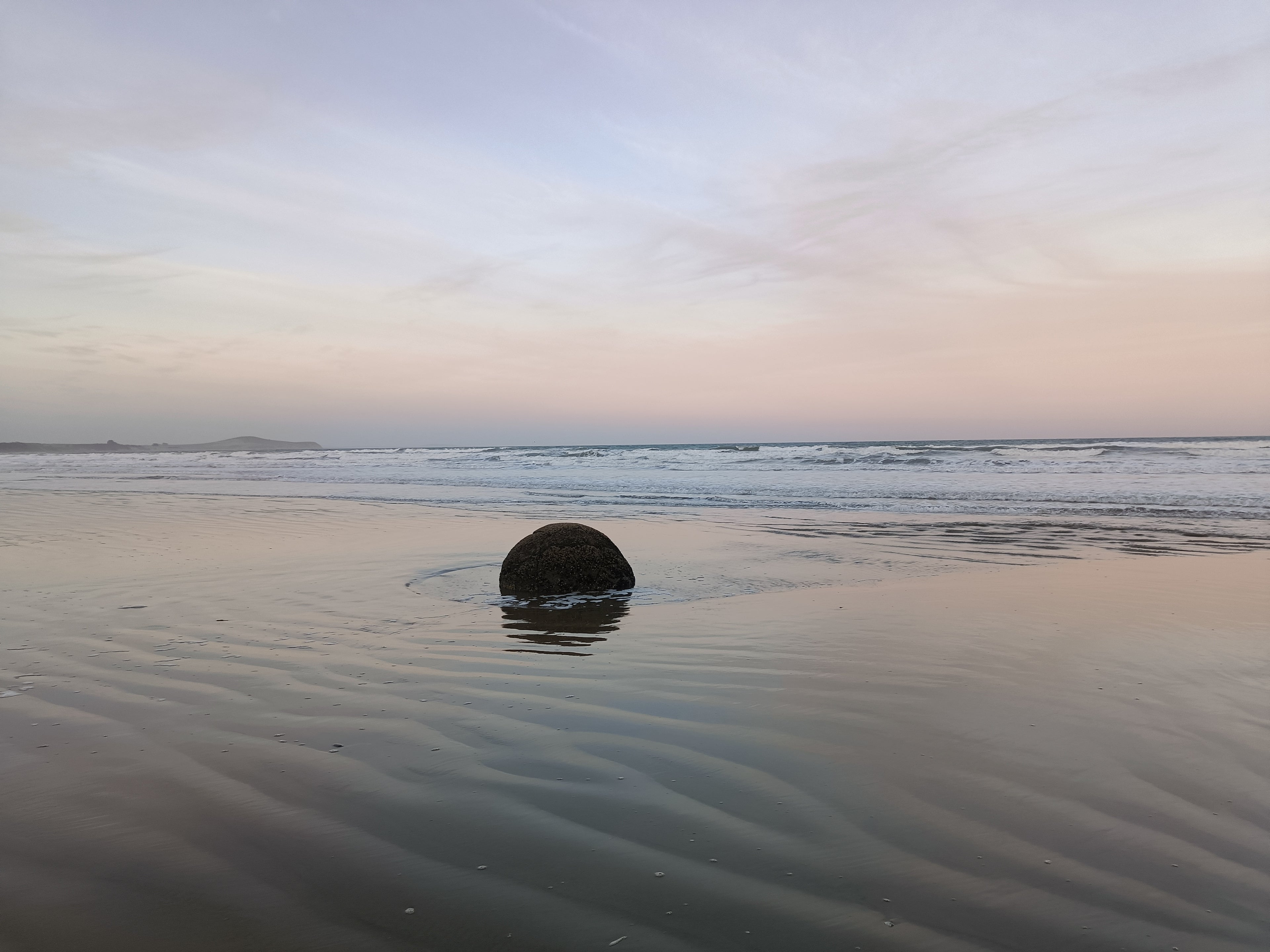 Round boulders on the beach at Moeraki, a famous geological site in New Zealand